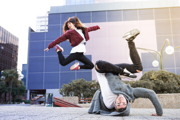 Young happy couple dancing on the street