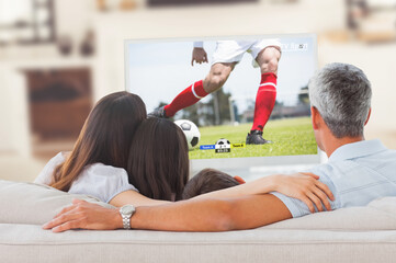 Poster - Happy caucasian family watching football match together and sitting on the couch