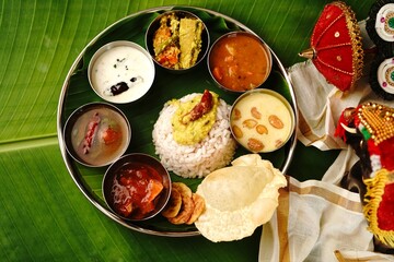 Wall Mural - Kerala Ona sadya Onam feast - vegetarian thali served on a round plate with banana leaf