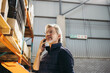 © Jacob Lund - Senior man taking a phone call in a distribution warehouse