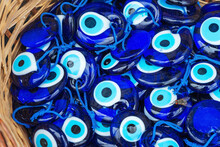 Turkish Cursed Eye In The Market. Muslim Blue Eye At The Merchant On The Counter. Texture Of Glass Spilled Eyes