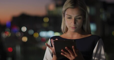 Wall Mural - Video of thoughtful caucasian businesswoman using tablet at night in office