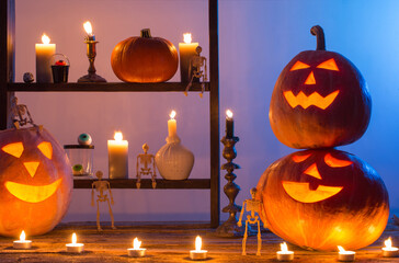 Wall Mural - halloween pumpkins with candles on wooden table