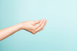 Italian hand gesture. Woman hand Italian gesture on light blue background. Front view, copy space