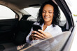 © kleberpicui - Businesswoman using smartphone in the car