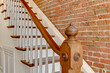 Wooden banister railing historic brick wall