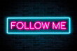 Follow Me neon banner on brick wall background.