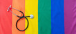 © Omeca - LGBT Health care. Medical Stethoscope on rainbow pride flag background, overhead view