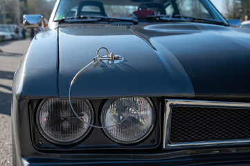 Detail of an old sports car, gray Ford Capri with two black stripes