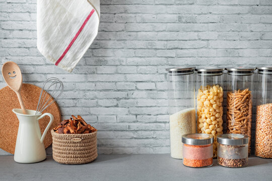 Wall Mural - pasta, cereals, rice on the kitchen table in transparent jars, storage and order in the kitchen