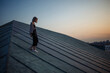 © maxbelchenko - Photo shoot on the roof. Young woman posing in the roof, amazing view of city. People, lifestyle, relaxation concept.