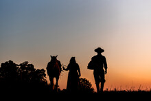 Horse And Gaucho Family On Field At Sunset Silhouette