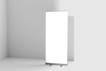 Wall Mural - Blank white roll-up banner display mockup on wall background, isolated, 3d rendering. Ready to display your design