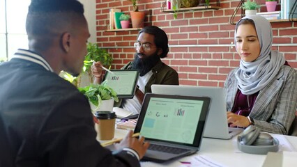 Poster - Diversity, woman in a hijab and a team in meeting at marketing startup. Teamwork, coaching and advertising, man with digital report on tablet. Technology, leadership and a web designer in the office.