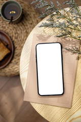 Poster - mockup blank screen mobile on round table with sunlight