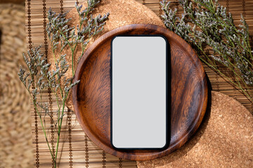 Poster - mockup blank screen smartphone on wood food plate on mat