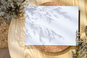 Wall Mural - Mockup paper poster card  on round table with grass flower