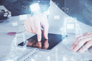 Poster - Double exposure of man's hands holding and using a digital device and envelop hologram drawing. E-mail concept.