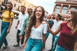 Multiracial group of friends hanging out together in the city center - Happy young people having fun walking outdoors - Friendship concept with guys and girls enjoying weekend vacation