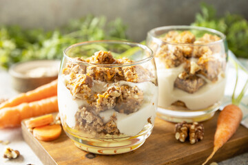 Wall Mural - Healthy dessert. Vegan gluten-free pastry. Carrot cake with walnuts and cinnamon in a glass on a light background.