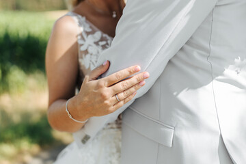 Bride's hand close-up on groom's arm