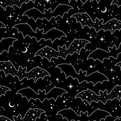 Silhouettes of cartoon bats on a black background. Seamless pattern