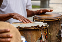 Percussionist Playing A Rudimentary Atabaque During Afro-brazilian Capoeira Fight Presentation In The Streets Of Pelourinho In Salvador City, Bahia