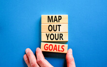Support And Map Out Your Goals Symbol. Concept Words Map Out Your Goals On Wooden Blocks On Beautiful Blue Table Blue Background. Businessman Hand. Business, Support And Map Out Your Goals Concept