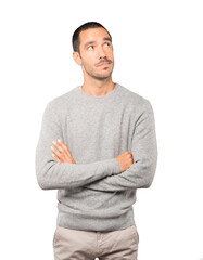 Wall Mural - Serious young man looking against background