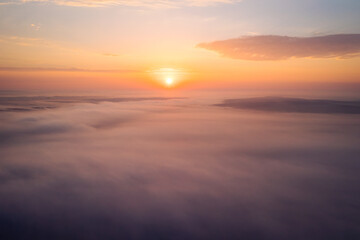 Poster - Bird's eye view of the fantastic ocean of clouds at sunrise. Aerial photography, drone shot.