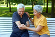 © Alex Tihonov - Elderly man got injured arm during stroll with wife outdoor