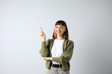 Canvas Print - Beautiful young girl pointing on white background