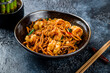 egg noodles with shrimps on dark stone table, Chinese cuisine