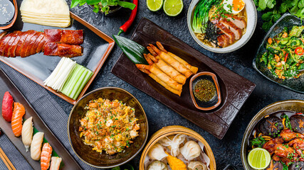Wall Mural - assorted dishes of Chinese cuisine on table. Spring rolls fried with shrimps, soup with duck, broken cucumbers,Pekin duck, rice with shrimps and chicken, dim sum, assorted sushi, top view