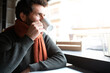 © Daniel - Pensive man looking out the window, drinking morning coffee in coffee shop. Copy space.