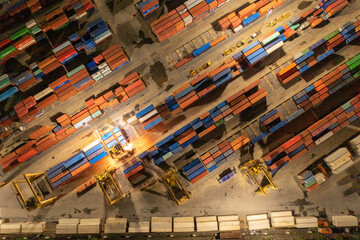 Wall Mural - Aerial view of container cargo ship in the export and import business and logistics international goods in urban city. Shipping to the harbour by crane in Bangkok harbour, Thailand at night.