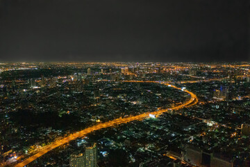 Poster - Aerial view of highway street road at Bangkok Downtown Skyline, Thailand. Financial district and business centers in smart urban city in Asia. Skyscraper and high-rise buildings at night.