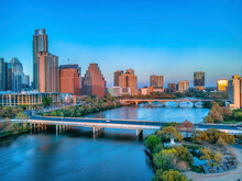 Park And Bridges Over The Colorado River Near The Austin, Texas Cityscape During Sunset