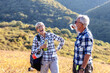 © pucko_ns - Two senior adult have pause on hiking and drink water and smile in natural environment