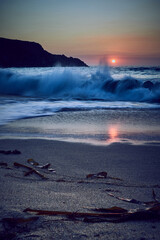 Wall Mural - Sunset on the beach of Mar do Rostro, Finisterre, Galicia, Spain. This beach is one of the most westerly in Europe, so people go there to see one of the most impressive sunsets in northern Spain