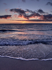 Wall Mural - Sunset on the beach of Mar do Rostro, Finisterre, Galicia, Spain. This beach is one of the most westerly in Europe, so people go there to see one of the most impressive sunsets in northern Spain