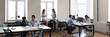© fizkes - Modern office space with diverse working busy employees. Business team working on project at workplaces, talking at laptop, typing at desktop, discussing tasks. Banner shot