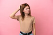 © luismolinero - Young English woman isolated on pink background having doubts while scratching head