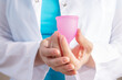 © yta - the gynecologist holds a menstrual cup, the doctor recommends a modern eco-friendly hygiene product for use during menstruation