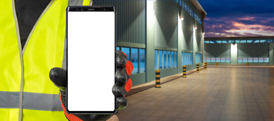 Poster - Industrial application. Mobile phone in hands factory worker. Man with phone near blurred factory building. Smartphone with white screen. Phone for industrial offer. Place for site industrial company