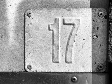 The Number 17 In On A Metal Plate In Black And White
