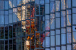 Crane reflecting in a glass facade