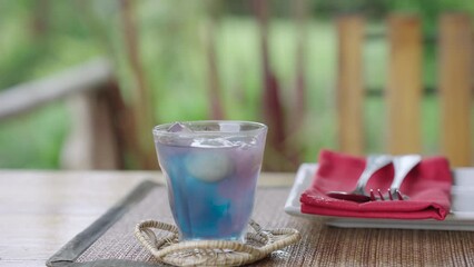 Wall Mural - Refreshing summer drink, Butterfly pea flower iced juice with lime or lemons organic blue and violet, Fresh herbal healthy detox drink.