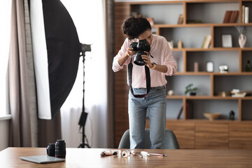 Wall Mural - Woman beauty blogger taking photo of cosmetics, using camera