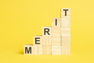 Poster - merit - text on wooden cubes, yellow background